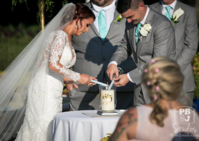 Bride and groom lighting candle