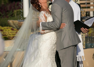 Bride and groom kissing at wedding