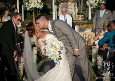 Bride and groom kissing at wedding