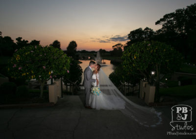 Bride and groom kissing at sunset