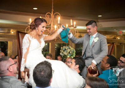 Bride and groom on shoulders