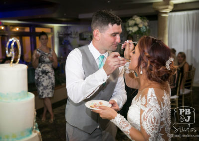 Bride and groom eating wedding cake