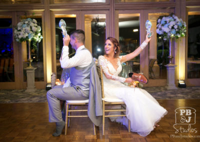 Bride and groom holding shoes