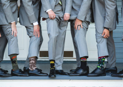 Groomsmen wearing dinosaur socks