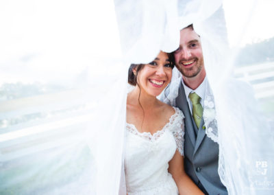Scott and Jocelyn under wedding veil
