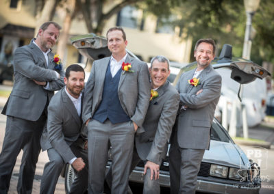 Todd with groomsmen next to Delorean