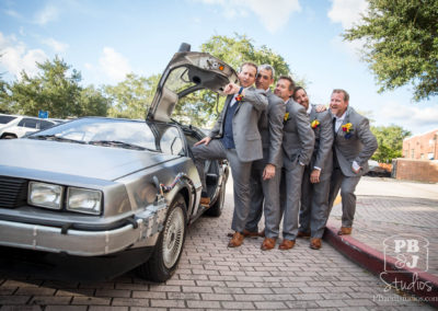 Todd checking the time entering Delorean with groomsmen