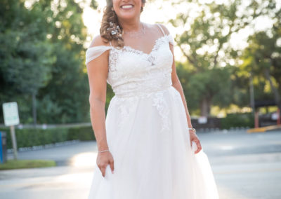 Renette posing outside in wedding dress