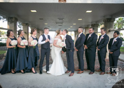 Kate and Steven kissing with wedding party