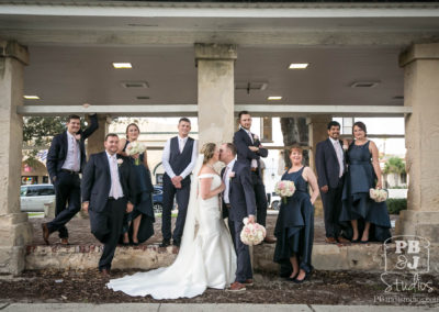 Kate and Steven kissing with wedding party