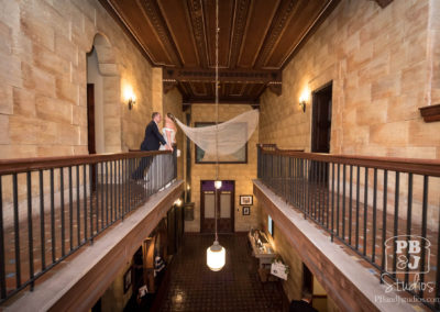 Kate and Steven with wedding veil flying in the wind