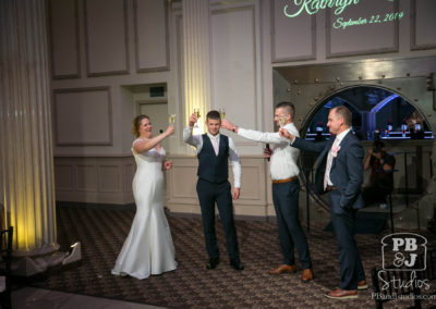 Kate Steven best man and maid of honor cheering with champagne